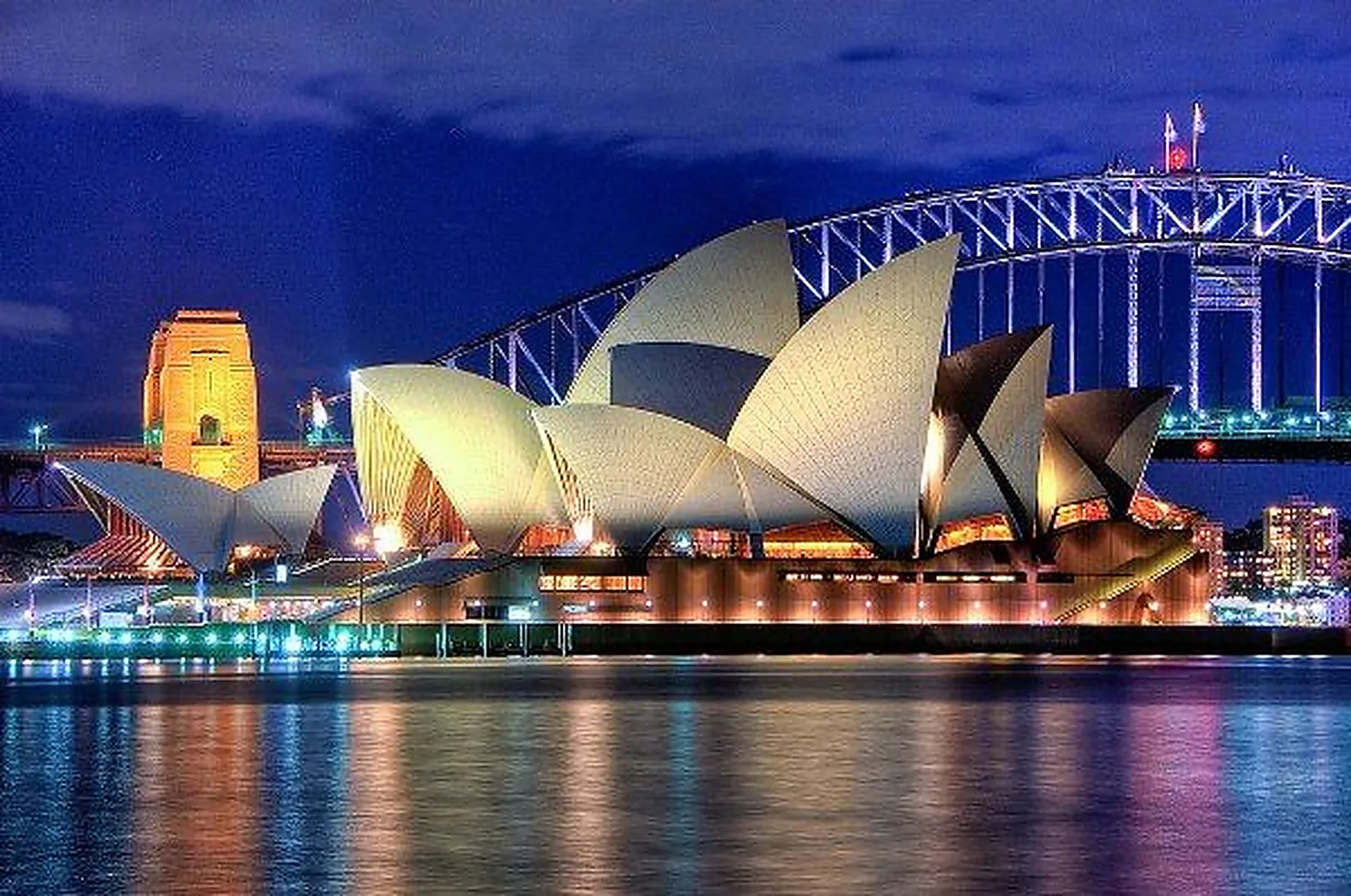 The Sydney Opera House and Harbour Bridge lit up at night